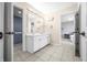 Bathroom with double sinks and tile flooring with access to the bedroom at 1032 Westview Point Dr, Columbus, IN 47201