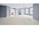 Spacious carpeted bedroom with neutral tones, a ceiling fan, and access to the hallway and backyard at 1032 Westview Point Dr, Columbus, IN 47201