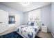 A bedroom features a bed with blue floral sheets, carpet flooring, and white nightstand at 1032 Westview Point Dr, Columbus, IN 47201