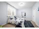 A bedroom features a bed with blue floral sheets, carpet flooring, and a mirror at 1032 Westview Point Dr, Columbus, IN 47201