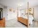Bedroom featuring neutral walls and carpet, large window, and a four poster bed at 1032 Westview Point Dr, Columbus, IN 47201