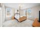Bedroom featuring neutral walls and carpet, a large window, and a four poster bed at 1032 Westview Point Dr, Columbus, IN 47201