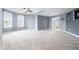 Well-lit carpeted bedroom with three windows, ceiling fan, and ensuite bathroom at 1032 Westview Point Dr, Columbus, IN 47201