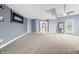 Large bonus room with neutral carpet, ceiling fan, and access to the backyard at 1032 Westview Point Dr, Columbus, IN 47201