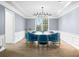 Bright and airy dining room with seating for eight, modern chandelier, and wainscoting at 1032 Westview Point Dr, Columbus, IN 47201