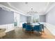 Dining area showcasing a modern chandelier, and a bar cart near the window for elegant entertaining at 1032 Westview Point Dr, Columbus, IN 47201