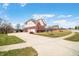 Exterior of the home features a brick facade, a well-manicured lawn, and a wide driveway leading to a two-car garage at 1032 Westview Point Dr, Columbus, IN 47201