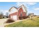 Charming home with a well-kept lawn, two car garage, and lush bushes at 1032 Westview Point Dr, Columbus, IN 47201
