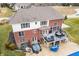 Aerial shot of the back of the home with a patio, outdoor seating, and a hot tub area at 1032 Westview Point Dr, Columbus, IN 47201