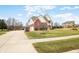 Charming two-story brick home with a well-manicured lawn and long driveway at 1032 Westview Point Dr, Columbus, IN 47201