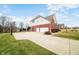 Wide driveway, two car garage, and basketball net on this nicely landscaped home at 1032 Westview Point Dr, Columbus, IN 47201