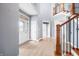 Spacious foyer with hardwood floors, staircase, and a decorative glass front door at 1032 Westview Point Dr, Columbus, IN 47201