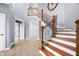 Elegant two-story foyer with hardwood floors and a staircase with wood and iron banister at 1032 Westview Point Dr, Columbus, IN 47201