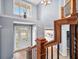 Grand two-story foyer with hardwood floors, chandelier, and staircase, creating an impressive entrance at 1032 Westview Point Dr, Columbus, IN 47201