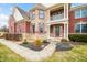 Inviting entryway featuring manicured landscaping, brick and stone facade at 1032 Westview Point Dr, Columbus, IN 47201