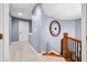 Upstairs hallway features neutral carpet, stylish trim, and a decorative wall clock, adding a touch of elegance at 1032 Westview Point Dr, Columbus, IN 47201