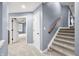 Inviting hallway with carpeted stairs and open doorway leading to a sunlit room at 1032 Westview Point Dr, Columbus, IN 47201