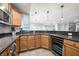 A kitchen features wooden cabinets, stainless steel appliances, tile flooring, and a wine cooler at 1032 Westview Point Dr, Columbus, IN 47201