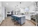 Bright open kitchen with island seating, modern appliances, and seamless flow into the living space at 1032 Westview Point Dr, Columbus, IN 47201