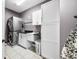 Well-organized laundry room with front-load washer/dryer, storage cabinets, and a utility sink, maximizing efficiency at 1032 Westview Point Dr, Columbus, IN 47201