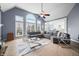 Bright living room featuring a large sectional sofa, vaulted ceiling, and expansive windows at 1032 Westview Point Dr, Columbus, IN 47201