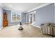 Bright living room featuring hardwood floors, large windows, and a cozy armchair, creating an inviting space at 1032 Westview Point Dr, Columbus, IN 47201