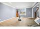This living room features hardwood floors, a traditional corner cabinet and large windows offering lots of natural light at 1032 Westview Point Dr, Columbus, IN 47201