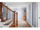 Elegant living room with hardwood floors, light blue walls, and an ornate staircase at 1032 Westview Point Dr, Columbus, IN 47201