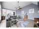 Spacious living room with gray sectional sofa, modern decor, and open layout to the kitchen at 1032 Westview Point Dr, Columbus, IN 47201