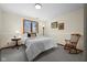 Comfortable bedroom with neutral tones, a cozy window view, and a classic rocking chair at 1086 Pebble Brook Dr, Noblesville, IN 46062
