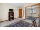 Carpeted bedroom featuring a mirrored closet, bookshelf, and a view of an adjacent room at 1086 Pebble Brook Dr, Noblesville, IN 46062