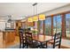 Dining room with wooden table, chairs, and large windows overlooking yard at 1086 Pebble Brook Dr, Noblesville, IN 46062