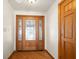 Inviting entryway features a decorative glass front door and beautiful wood floors at 1086 Pebble Brook Dr, Noblesville, IN 46062
