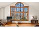 Bright living room featuring a large window with a scenic view and hardwood floors at 1086 Pebble Brook Dr, Noblesville, IN 46062