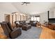 Spacious living room featuring hardwood floors, ample seating, and a rustic fireplace at 1086 Pebble Brook Dr, Noblesville, IN 46062