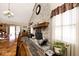 Dining area boasts a large table, seating, brick fireplace, wood-look floors, and lots of natural light at 12064 N Glena Pl, Mooresville, IN 46158