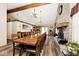A large dining area features a long table, chairs, brick fireplace, and wood-look floors for Gathering gatherings at 12064 N Glena Pl, Mooresville, IN 46158