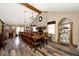 Large dining area features an extra long wooden table, chairs, and a brick fireplace as a main focal point at 12064 N Glena Pl, Mooresville, IN 46158