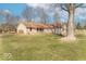 Expansive lawn showcases home with brick and siding, mature trees, and a cozy, inviting atmosphere at 12064 N Glena Pl, Mooresville, IN 46158