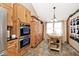 Well-equipped kitchen featuring wooden cabinetry, stainless steel appliances, and a stylish kitchen island at 12064 N Glena Pl, Mooresville, IN 46158
