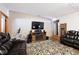 Comfortable living room features leather furniture, an electric fireplace, and an entertainment center with a TV at 12064 N Glena Pl, Mooresville, IN 46158