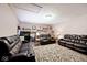 Spacious living room featuring comfortable leather sofas, a decorative rug, and ample entertainment options at 12064 N Glena Pl, Mooresville, IN 46158