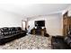 Comfortable living room with leather seating, an electric fireplace, and a large TV for entertainment at 12064 N Glena Pl, Mooresville, IN 46158