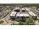 An aerial view showing multiple buildings, landscaping, pond and parking spaces at 15 W Executive Dr # 104, Carmel, IN 46032