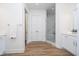 Well lit bathroom with a glass shower, double closets, and luxury vinyl flooring at 15 W Executive Dr # 104, Carmel, IN 46032