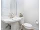 Modern half-bathroom featuring pedestal sink and toilet at 15 W Executive Dr # 104, Carmel, IN 46032
