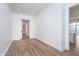 Bright room with light wood floors and white walls, sliding door closet, and ensuite bathroom access at 15 W Executive Dr # 104, Carmel, IN 46032