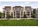 An apartment building with modern brick and siding, a generous green space, and mature shade trees at 15 W Executive Dr # 104, Carmel, IN 46032