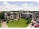 A view of upscale apartments with balconies overlook the spacious green common area and seating at 15 W Executive Dr # 104, Carmel, IN 46032