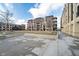 Modern apartment building exterior featuring private balconies, pedestrian walkways, and sidewalk in front on a sunny day at 15 W Executive Dr # 104, Carmel, IN 46032